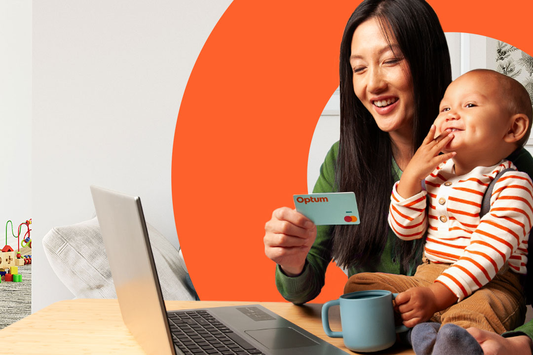 Mother and daughter seated on a sofa, mother is holding an Optum Financial health account card